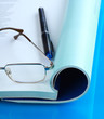 Open journals with glasses in front