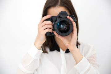 Sticker - Female photographer with camera over gray background