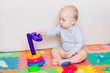 © len44ik - Cute little baby playing with colorful toys
