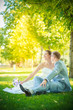 © lobodaphoto - Bride and groom sitting on the lawn