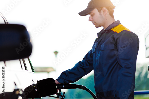 Fotografie, Obraz Gas station worker refilling car at service station