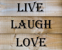 Live Laugh Love Quote On A Wooden Background
