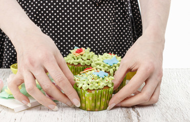 Sticker - Woman decorates easter cupcakes