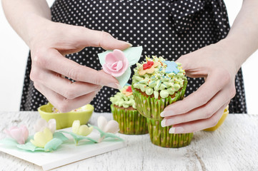 Sticker - Woman decorates easter cupcakes