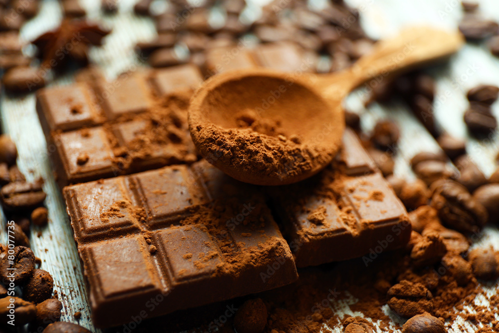 Still life with chocolate, grains and cocoa on wooden