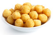Bowl of fried small potato balls on white.