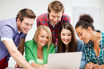Wall Mural - international students looking at laptop at school