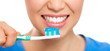 © Stasique - Healthy teeth and breath concept. Happy woman cleaning her teeth