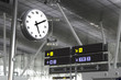 Clock and signs at an airport
