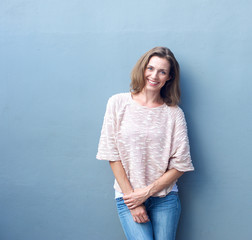 attractive mid adult woman smiling on gray background