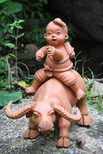 Traditional Sculpture Of A Boy Riding Waret Buffalo