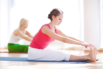 Two yogas woman indoors