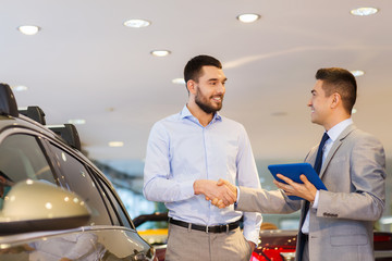 Wall Mural - happy man shaking hands in auto show or salon