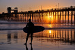 Surfer near the Oceanside Pier, Southern California, USA