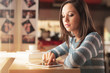 © stokkete - Young woman at the bar using a tablet