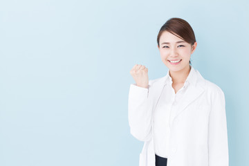 Sticker - young asian doctor on blue background