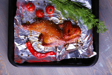 Sticker - Smoked chicken leg with cherry tomatoes on pan on table close