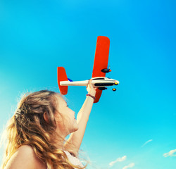 Wall Mural - Girl playing with plane