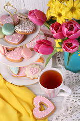 Wall Mural - Composition of spring flowers, tea and cookies on table