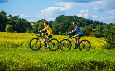 Wall Mural - Healthy lifestyle - teenage girl and boy biking