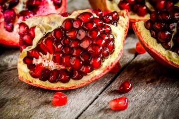 ruby juicy pomegranate grains closeup on a table