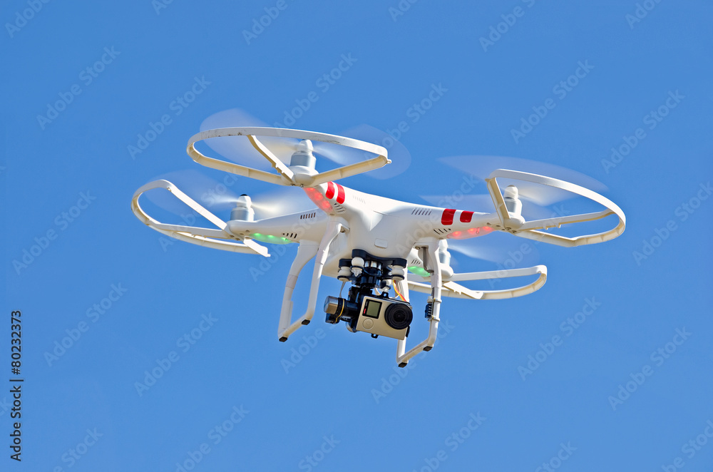 white drone hovering in blue sky - obrazy, fototapety, plakaty 