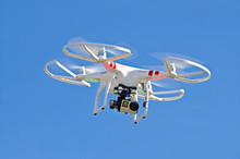 White Drone Hovering In Blue Sky