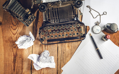 Text prescribed on a vintage typewriter and watch timekeeper.