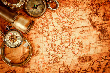 vintage magnifying glass lies on an ancient world map