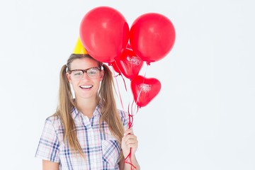Aufkleber - Geeky hipster smiling at camera and holding red balloons