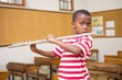 © WavebreakMediaMicro - Cute pupil playing flute in classroom