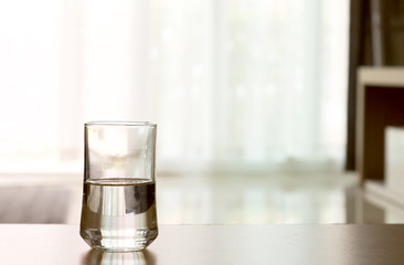 Wall Mural - closeup Glass of water on table in the living room