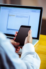 Man using laptop and smartphone