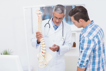 Doctor explaining the spine to his patient