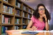 © WavebreakMediaMicro - Student sitting in library writing