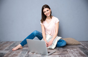 Sticker - Happy woman sitting on the floor with laptop