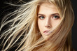 Leinwandbild Motiv Portrait of blonde girl with fluttering hair