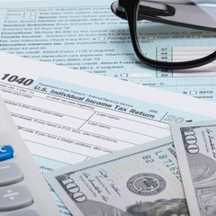 Wall Mural - US 1040 Tax Form, calculator, glasses and dollars - studio shot