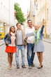 © Syda Productions - group of smiling friends with map and photocamera
