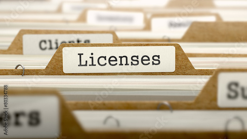 Fotomural Licenses Concept with Word on Folder.
