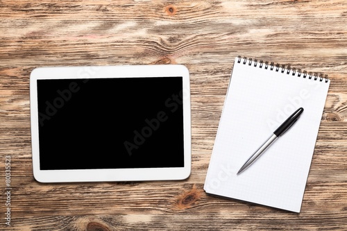 Tela Analysis. Digital tablet on wooden tablets with notepad and pen