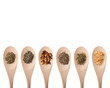 Several spices on wood spoon isolated on a white background