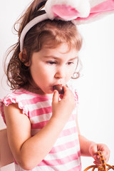 Wall Mural - Girl eats a chocolate eggs