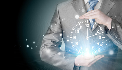 Image of businessman holding clock against illustration