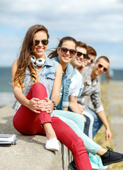 Wall Mural - teenage girl hanging out with friends outdoors