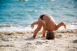 © alexytrener - Boy standing on head near sea