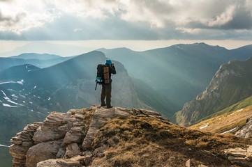 Wall Mural - Tourist looks at mountains