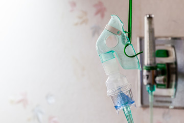 close-up image of a medical oxygen mask and valve setting blurry