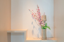 Bamboo Vase With Cherry Blossom On A Shelf