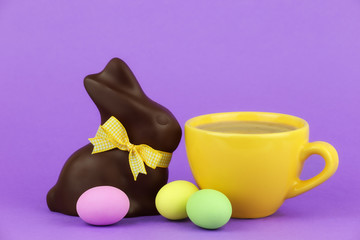 Happy Easter concept - cappuccino with chocolate bunny and eggs